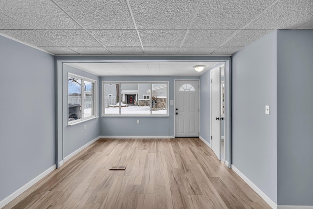 entryway with a paneled ceiling and light wood-type flooring