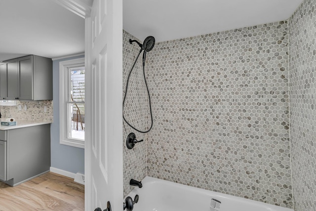 bathroom featuring hardwood / wood-style flooring and tub / shower combination