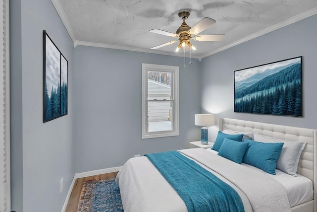 bedroom with hardwood / wood-style flooring, ceiling fan, and crown molding