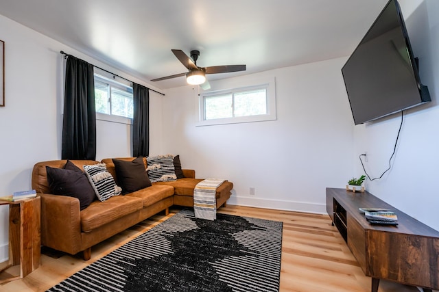 living room featuring ceiling fan and light hardwood / wood-style flooring