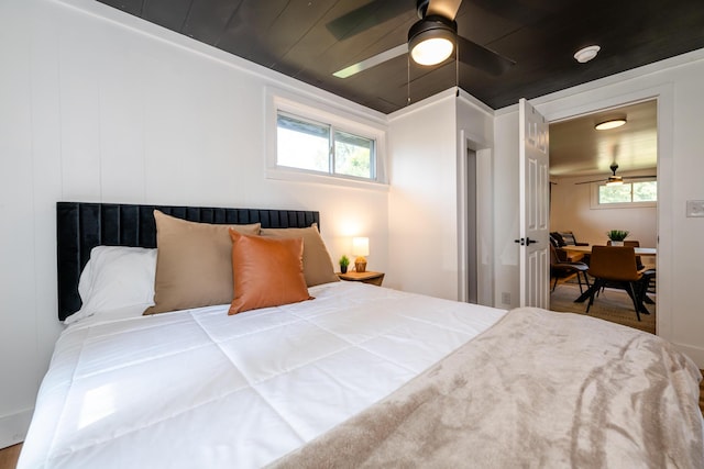 bedroom with ceiling fan and multiple windows