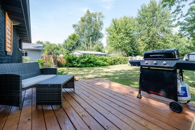 wooden deck with a yard and an outdoor hangout area