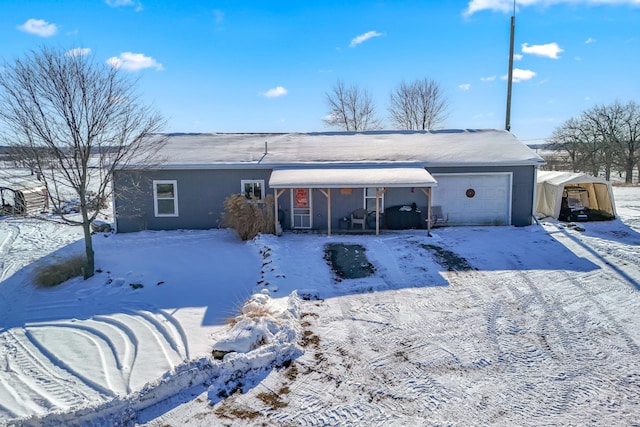 snow covered house with a garage