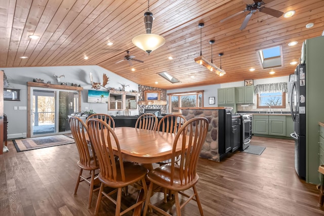 dining area featuring hardwood / wood-style flooring, ceiling fan, and wood ceiling