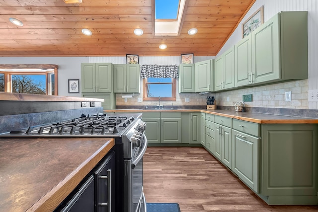 kitchen featuring green cabinetry, wood ceiling, and sink