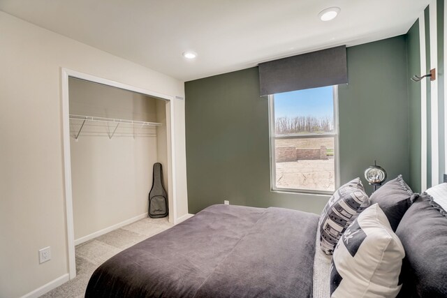 bedroom with a closet and light carpet