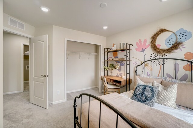 bedroom featuring a closet and light colored carpet