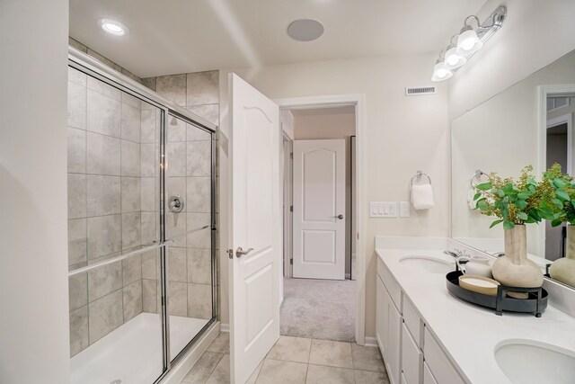 bathroom featuring vanity, walk in shower, and tile patterned floors