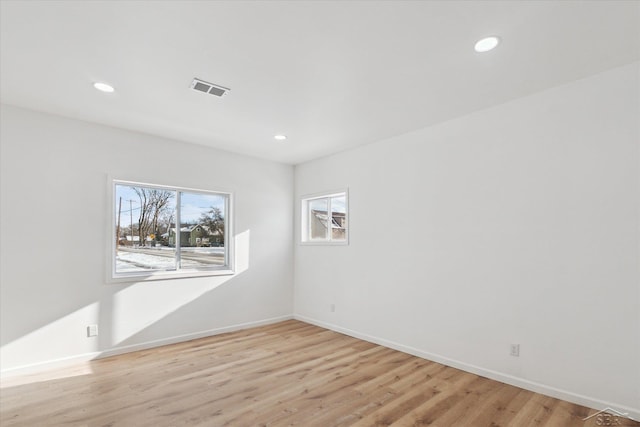 spare room with light hardwood / wood-style floors