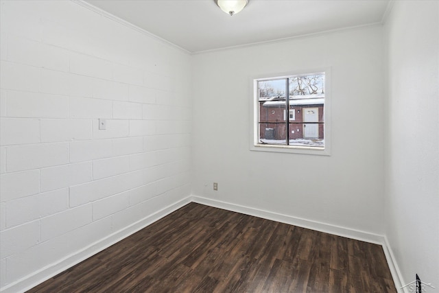 empty room featuring crown molding and dark hardwood / wood-style flooring