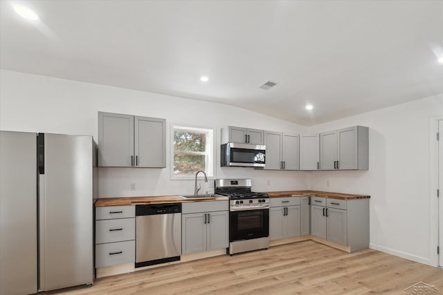 kitchen with stainless steel appliances, sink, and gray cabinets