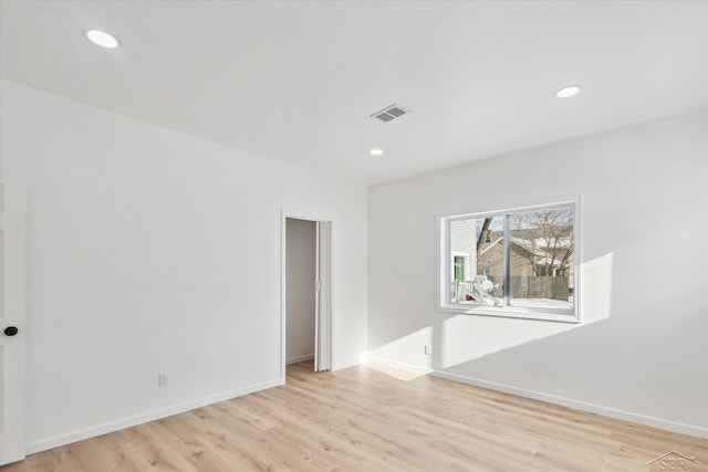 spare room featuring light wood-type flooring