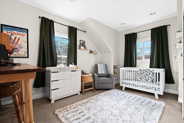 bedroom featuring a crib and carpet flooring