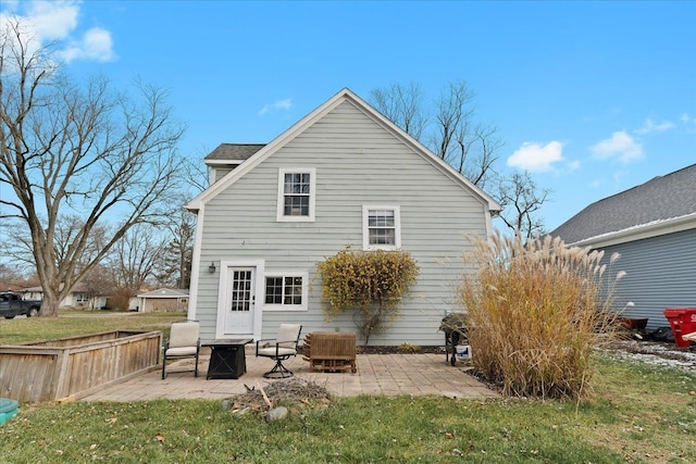 rear view of house featuring a patio and a yard