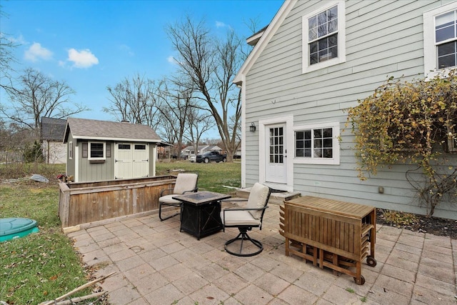 view of patio / terrace with an outdoor fire pit and a storage unit