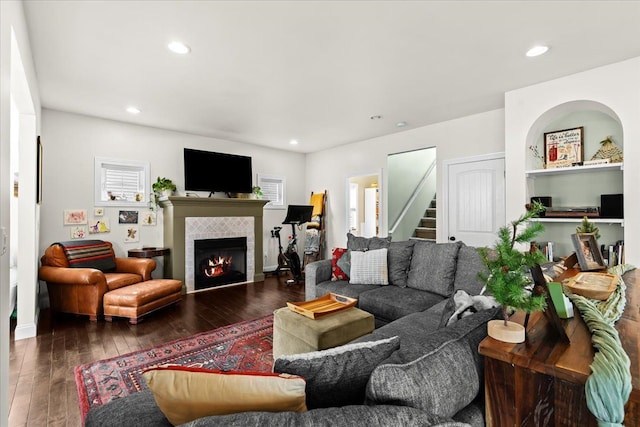 living room featuring a fireplace, dark hardwood / wood-style flooring, and plenty of natural light