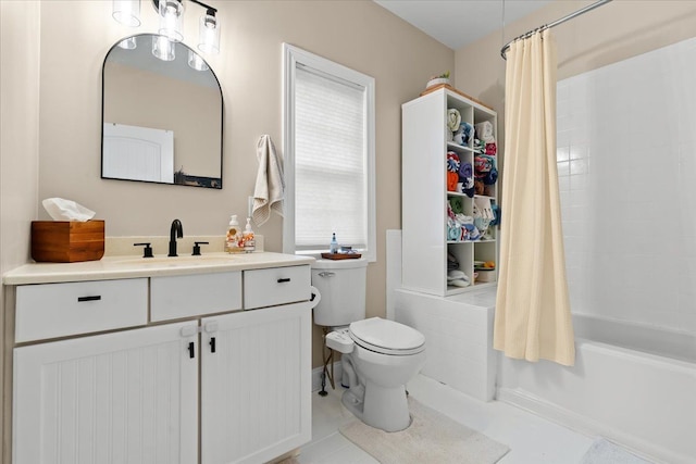 full bathroom featuring toilet, shower / bath combo with shower curtain, a wealth of natural light, and vanity