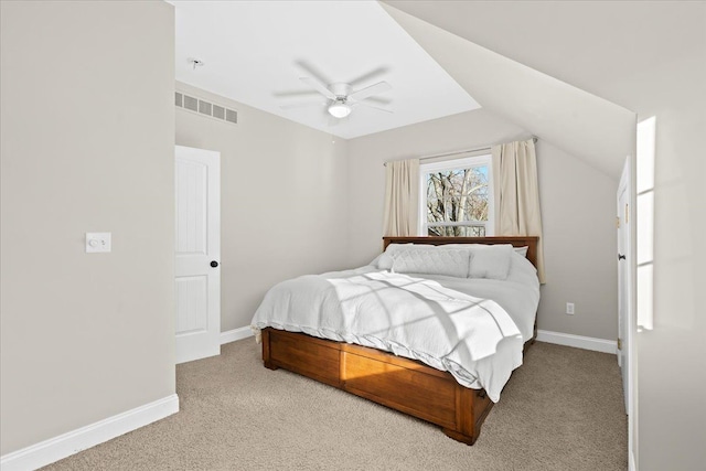 bedroom with vaulted ceiling, light colored carpet, and ceiling fan