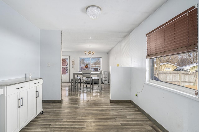 hall featuring a notable chandelier and dark hardwood / wood-style floors