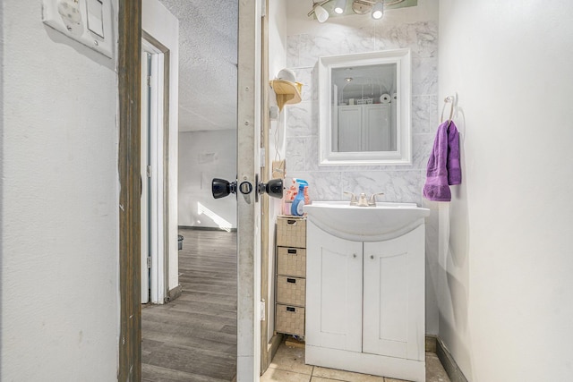 bathroom featuring a textured ceiling and vanity