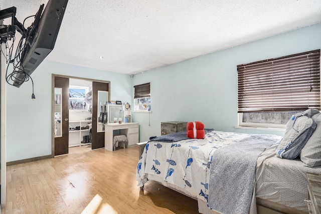 bedroom featuring a textured ceiling and light wood-type flooring