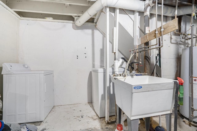 washroom with sink, washing machine and dryer, and water heater