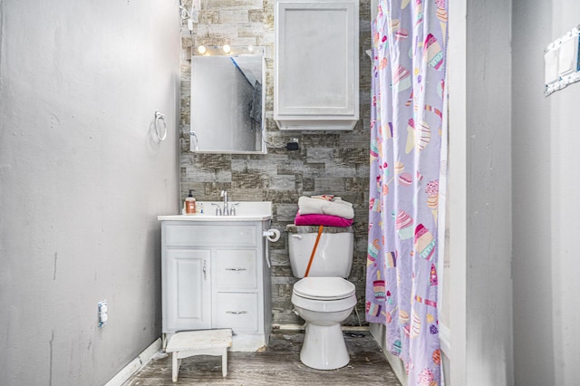 bathroom featuring toilet, vanity, hardwood / wood-style floors, and a shower with curtain