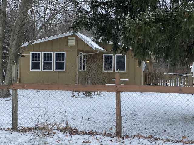 view of snow covered back of property