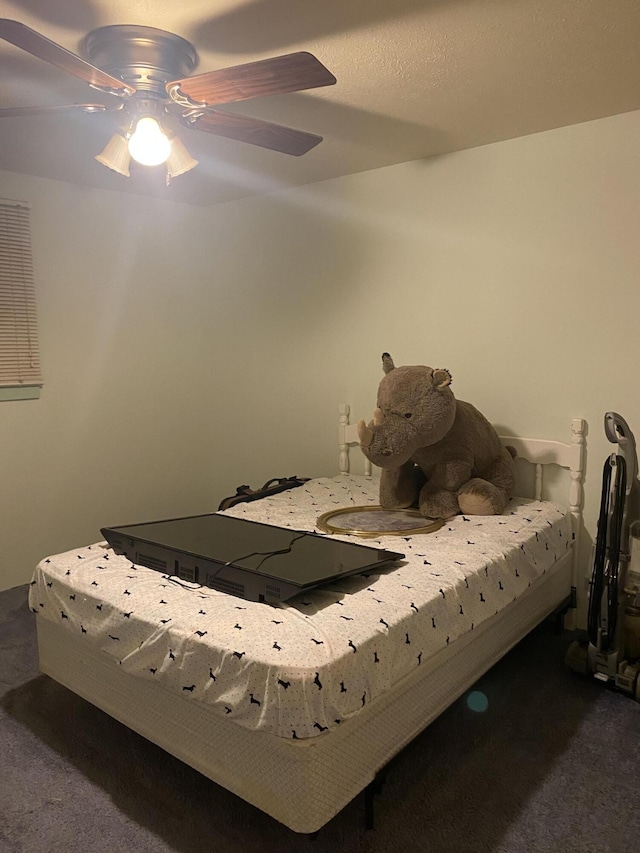 bedroom featuring dark colored carpet and ceiling fan