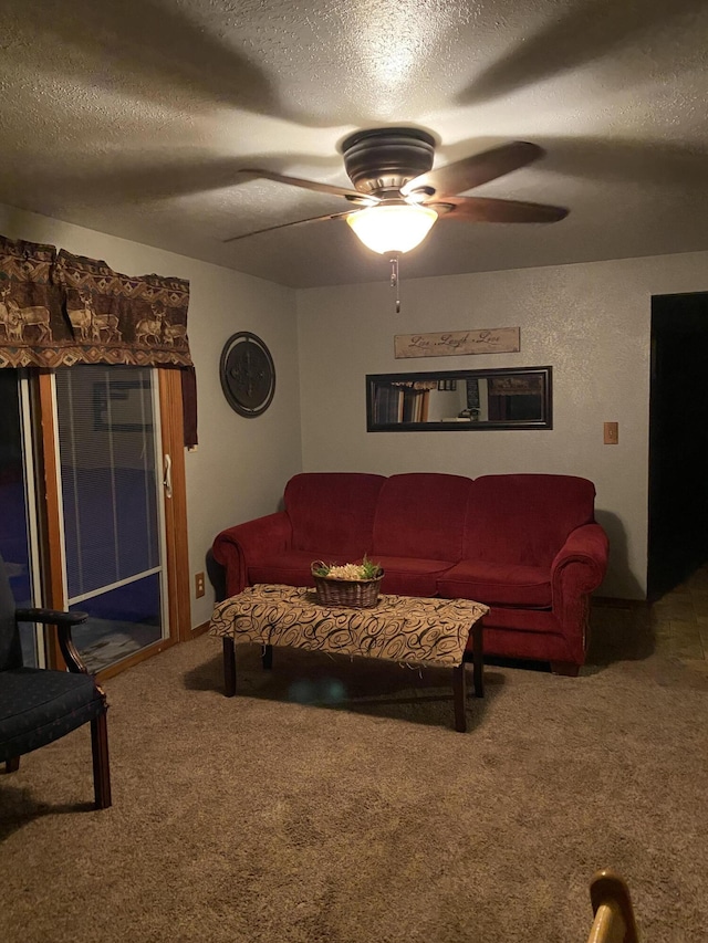 carpeted living room with a textured ceiling and ceiling fan