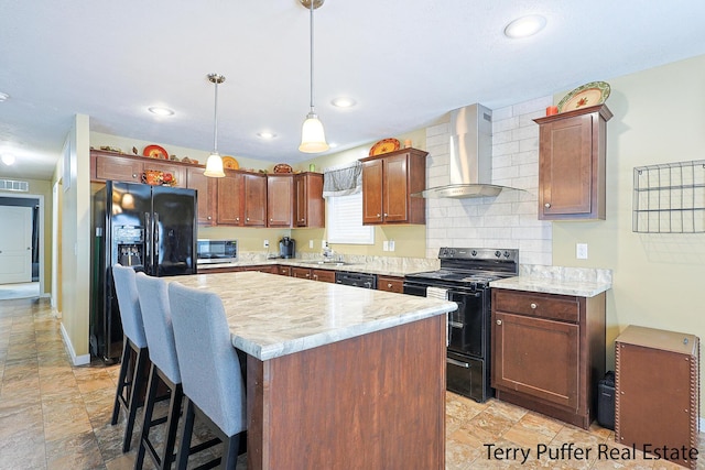 kitchen with black appliances, pendant lighting, a kitchen island, wall chimney exhaust hood, and sink