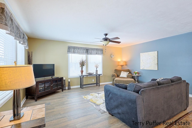 living room with light hardwood / wood-style floors and ceiling fan