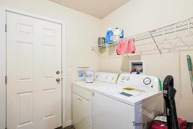 clothes washing area featuring separate washer and dryer