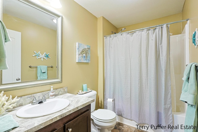 full bathroom featuring shower / bath combination with curtain, vanity, and toilet