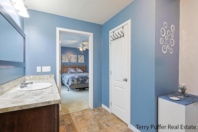 bathroom featuring a textured ceiling, ceiling fan, and vanity