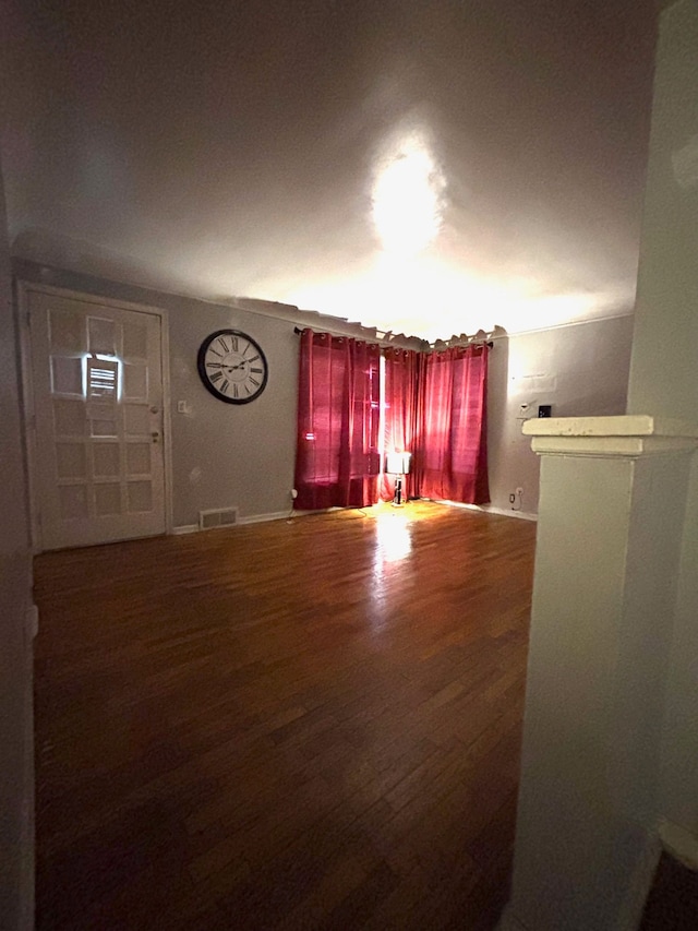 unfurnished living room with wood-type flooring