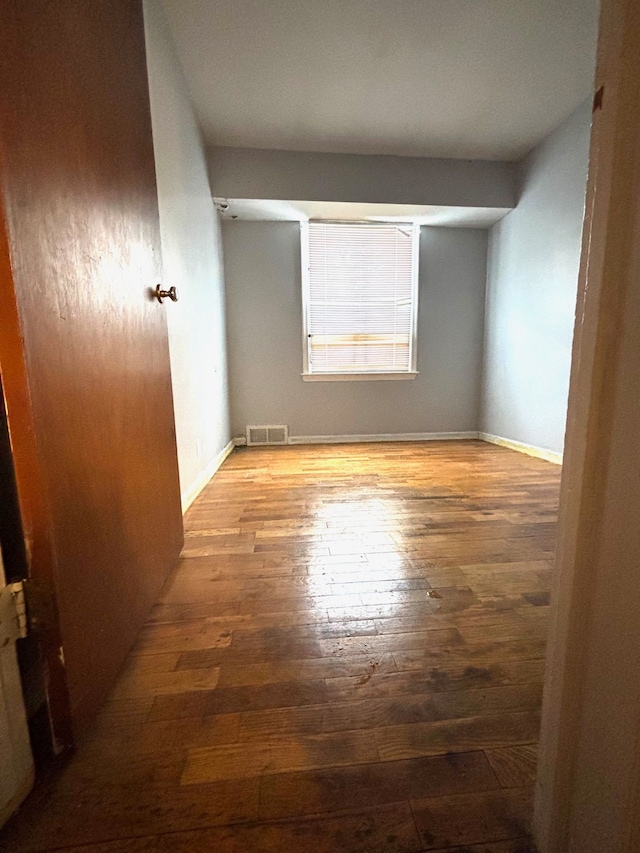 empty room with wood-type flooring