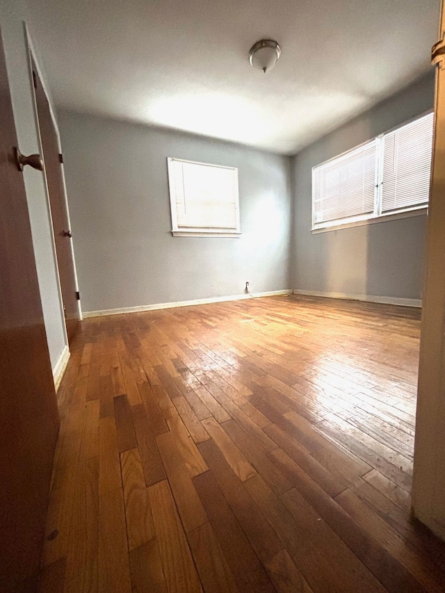 spare room with hardwood / wood-style flooring