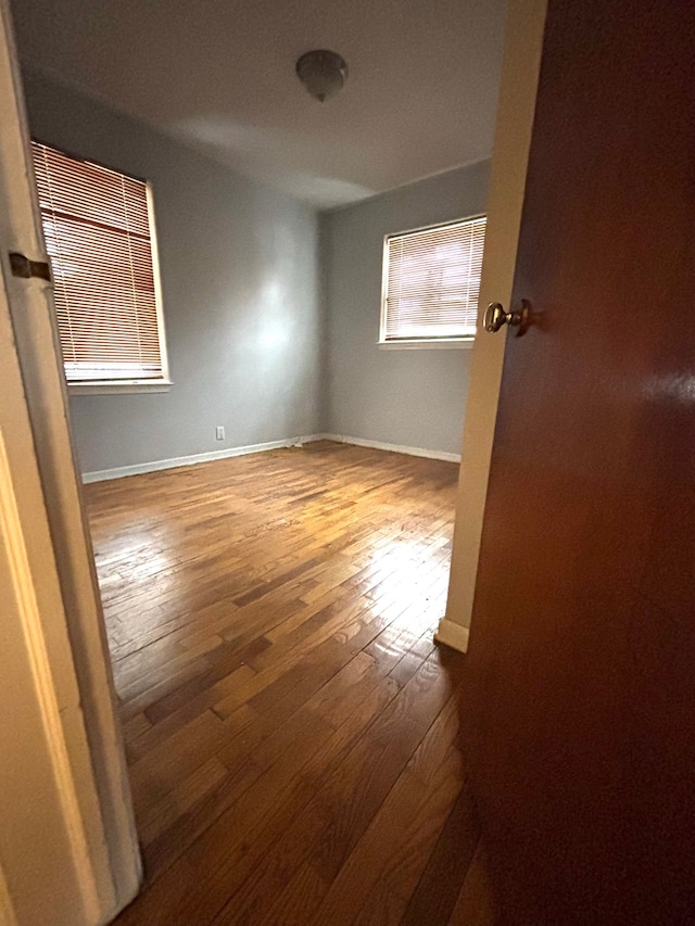 empty room with wood-type flooring