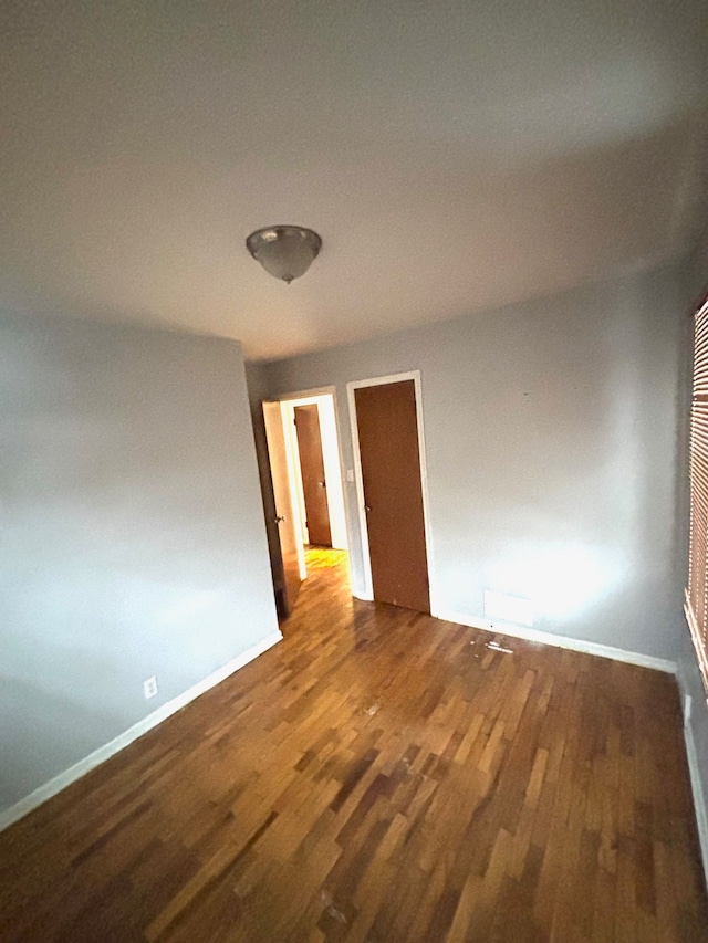 spare room featuring dark hardwood / wood-style floors