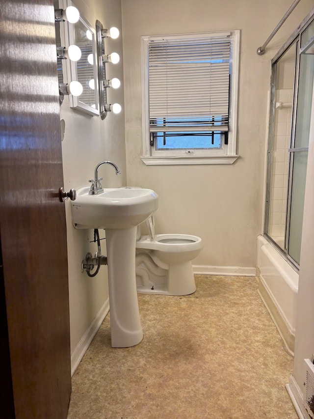 bathroom with toilet and enclosed tub / shower combo