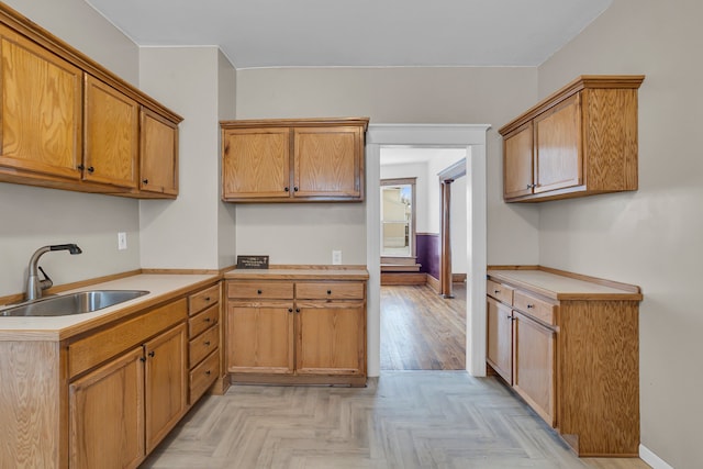 kitchen with sink and light parquet flooring