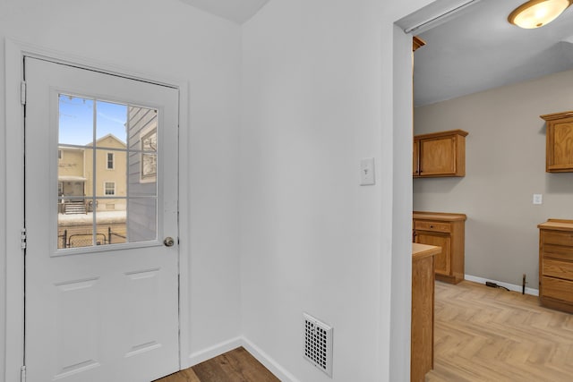 entryway with light parquet flooring