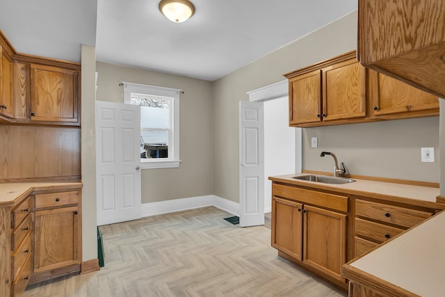 kitchen with sink and light parquet floors