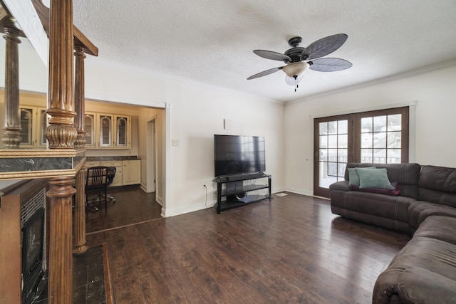 416 S Michigan Ave, Manton, MI 49663 - living room with a ceiling fan, dark wood-style floors, french doors, crown molding, and a textured ceiling