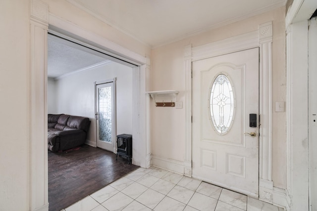 416 S Michigan Ave, Manton, MI 49663 - entrance foyer with a wood stove, crown molding, and baseboards