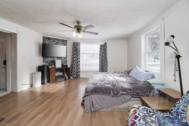 416 S Michigan Ave, Manton, MI 49663 - bedroom featuring wood finished floors, ornamental molding, a textured ceiling, and a ceiling fan