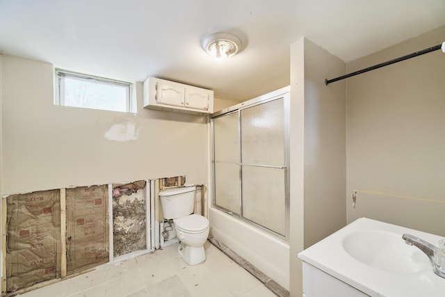 416 S Michigan Ave, Manton, MI 49663 - full bathroom with toilet, shower / bath combination with glass door, and vanity