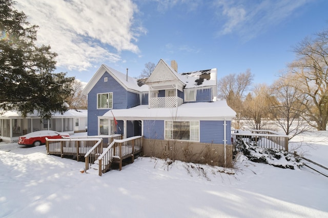 416 S Michigan Ave, Manton, MI 49663 - view of front of house featuring a wooden deck and a chimney