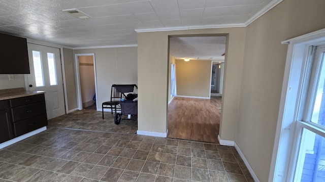 416 S Michigan Ave, Manton, MI 49663 - kitchen with crown molding, baseboards, and dark cabinets